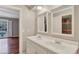Bathroom featuring double sinks, white cabinets, neutral paint, and access to the bedroom at 3649 Peachtree Ne Rd # 201, Atlanta, GA 30319