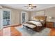 Bedroom featuring hardwood floors, neutral paint, large windows, and a wooden bed frame at 3649 Peachtree Ne Rd # 201, Atlanta, GA 30319