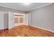 Bedroom with hardwood floors, open closet and neutral colored walls at 3649 Peachtree Ne Rd # 201, Atlanta, GA 30319