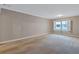 Spacious living room with neutral carpet, large window with light, and subtle decor at 3649 Peachtree Ne Rd # 201, Atlanta, GA 30319