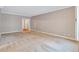 Open-plan living space with neutral color palette and access to additional rooms at 3649 Peachtree Ne Rd # 201, Atlanta, GA 30319