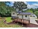 Back of house with yard and deck with furniture at 6914 Fairway Trl, Austell, GA 30168