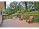 A spacious back deck with dark wood and seating for enjoying the backyard view at 6914 Fairway Trl, Austell, GA 30168