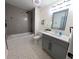 Stylish bathroom featuring a tub, shower, gray tile surround, decorative floor, and gray vanity at 6914 Fairway Trl, Austell, GA 30168