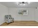 Bright bedroom with hardwood floors, modern light fixture and an accent chair at 6914 Fairway Trl, Austell, GA 30168