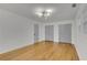 Spacious bedroom featuring hardwood floors, ample closet space, and a modern light fixture at 6914 Fairway Trl, Austell, GA 30168
