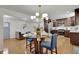 Dining area with modern lighting and adjacent open kitchen at 6914 Fairway Trl, Austell, GA 30168
