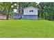 Charming two-story home with a large, well-manicured front lawn and newly painted blue exterior at 6914 Fairway Trl, Austell, GA 30168