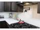 Modern kitchen featuring white backsplash, quartz countertops, dark wooden cabinets and stainless steel appliances at 6914 Fairway Trl, Austell, GA 30168