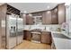 A well-lit kitchen boasts stainless steel appliances, dark wooden cabinets, and quartz countertops at 6914 Fairway Trl, Austell, GA 30168