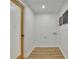 Hallway leading to laundry room, featuring wood flooring and light, neutral walls at 6914 Fairway Trl, Austell, GA 30168