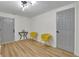 Bright living room with modern light fixture, yellow chairs and light wood floors at 6914 Fairway Trl, Austell, GA 30168