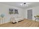 Bright living room with hardwood floors, modern lighting, and a cozy white sofa at 6914 Fairway Trl, Austell, GA 30168