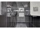 Modern shower with black tiled walls, built in honeycomb patterned shelving, and a rainfall shower head at 6914 Fairway Trl, Austell, GA 30168