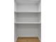 A small closet with three tiers of shelving and wood flooring at 6914 Fairway Trl, Austell, GA 30168