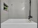 Bathtub with black faucet and gray tile surround at 6914 Fairway Trl, Austell, GA 30168