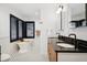 Bathroom with double vanity, black countertops, and a modern soaking tub at 956 Cardova Dr, Atlanta, GA 30324