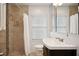 Clean bathroom with shower/tub combo, updated vanity, and tile flooring at 956 Cardova Dr, Atlanta, GA 30324