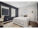 Bright bedroom with a white bed, accent wall, and a workspace at 956 Cardova Dr, Atlanta, GA 30324
