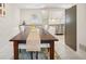 Dining area with dark wood table, white chairs and a view of the kitchen at 956 Cardova Dr, Atlanta, GA 30324