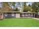 Charming ranch home with gray siding, stone accents, and a spacious lawn at 956 Cardova Dr, Atlanta, GA 30324