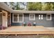 Relaxing front porch with pink door and two black chairs at 956 Cardova Dr, Atlanta, GA 30324