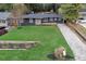 Mid-century modern home with a manicured lawn at 956 Cardova Dr, Atlanta, GA 30324