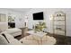 Modern living room with dark hardwood floors, white sectional sofa, and a large TV at 956 Cardova Dr, Atlanta, GA 30324