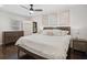 Spacious main bedroom with king-size bed, dark wood floors, and ceiling fan at 956 Cardova Dr, Atlanta, GA 30324