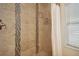 Shower with beige tile and mosaic accents at 956 Cardova Dr, Atlanta, GA 30324