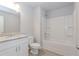 Well-lit bathroom featuring a shower-tub combo, vanity with granite countertop, and white cabinets at 6478 Beaver Creek Trl, Atlanta, GA 30349