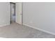 Bright bedroom with grey carpet and access to hallway at 6478 Beaver Creek Trl, Atlanta, GA 30349