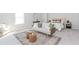 A spacious bedroom with a bed, couch, coffee table, rug, and window at 6478 Beaver Creek Trl, Atlanta, GA 30349