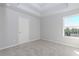 A bedroom with a window with a view of the trees and a door leading to another room at 6478 Beaver Creek Trl, Atlanta, GA 30349