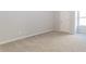 Neutral carpeted bedroom with natural light and open door at 6478 Beaver Creek Trl, Atlanta, GA 30349