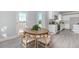 An open dining area with a view of the kitchen with an island and a door leading to the outside at 6478 Beaver Creek Trl, Atlanta, GA 30349