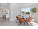 Bright dining area with large windows, views of the backyard, and modern decor at 6478 Beaver Creek Trl, Atlanta, GA 30349