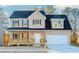 Two-story house with tan siding, dark roof, and a front porch at 6478 Beaver Creek Trl, Atlanta, GA 30349