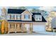 Two-story house with tan siding, dark roof, and a front porch at 6478 Beaver Creek Trl, Atlanta, GA 30349