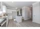 Bright, open kitchen with stainless steel appliances, granite countertops, and gray vinyl flooring at 6478 Beaver Creek Trl, Atlanta, GA 30349