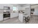 Modern kitchen features granite countertops, stainless steel appliances, and barstool seating at 6478 Beaver Creek Trl, Atlanta, GA 30349