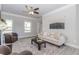 Well-lit living room features a comfortable couch and decor, complete with a ceiling fan at 6478 Beaver Creek Trl, Atlanta, GA 30349