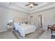 Spacious main bedroom with tray ceilings, a king-size bed, a large rug, and doorway entries at 6478 Beaver Creek Trl, Atlanta, GA 30349