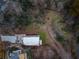 Aerial view displaying property, long driveway, neighboring homes, and the surrounding natural landscape at 247 Huntington Ne Rd, Atlanta, GA 30309