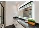 Modern bathroom with illuminated mirror, dark countertops, white cabinets and backsplash tile at 247 Huntington Ne Rd, Atlanta, GA 30309