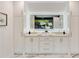 Well-lit bathroom vanity with double sinks, a large mirror, and ample storage space at 247 Huntington Ne Rd, Atlanta, GA 30309
