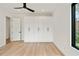 Bedroom featuring built-in closet storage, hardwood floors, modern lighting, and large windows at 247 Huntington Ne Rd, Atlanta, GA 30309