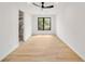Bright, spacious bedroom with hardwood floors, a large window, and an attached bathroom at 247 Huntington Ne Rd, Atlanta, GA 30309
