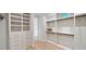 Bright walk-in closet features custom shelving, drawers, and hanging rods for optimal organization at 247 Huntington Ne Rd, Atlanta, GA 30309