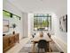 Bright dining room with large windows, light wood floors, and neutral decor at 247 Huntington Ne Rd, Atlanta, GA 30309